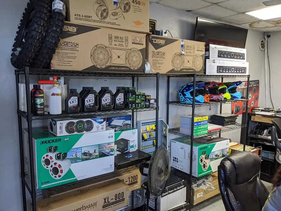Tires, oil and accessories stocked on the shelves at the TMT Offroad shop counter in Williston, FL